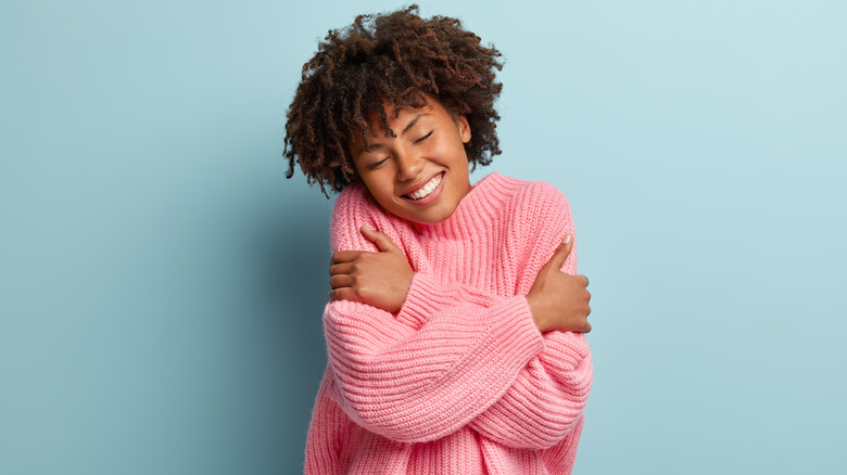 Woman hugging herself