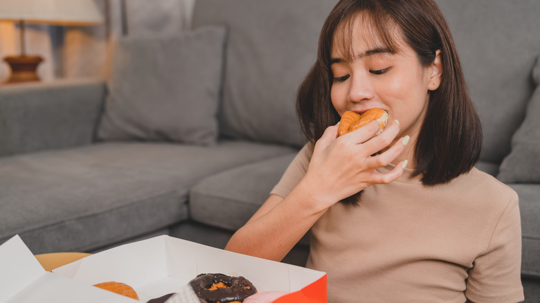 Woman eating donuts