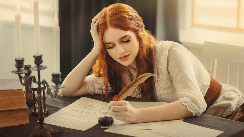 Woman writing a letter with a quill