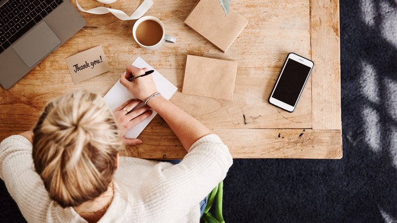 Woman writing thank you notes