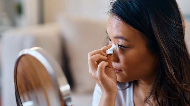 Woman removing eye makeup