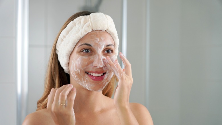 Woman using face cleanser