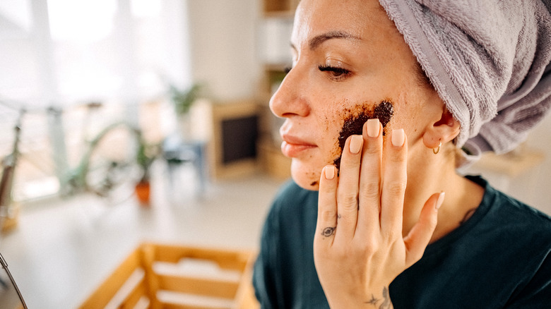 Woman exfoliating skin