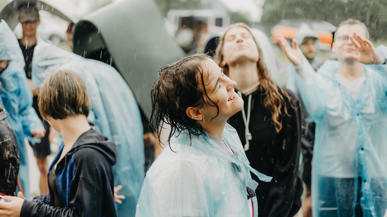 woman volunteering at concert enjoying rain