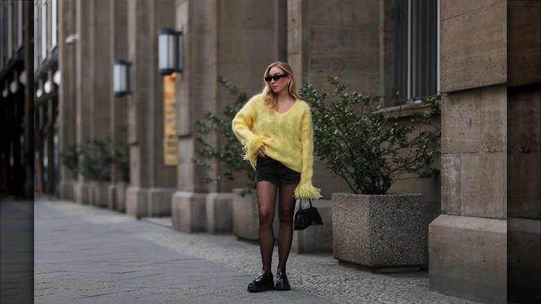 Woman wearing a yellow sweater.