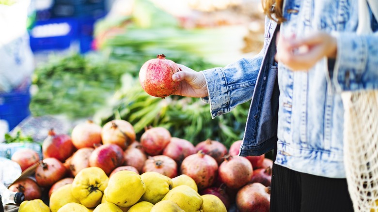 Person choosing apples at store