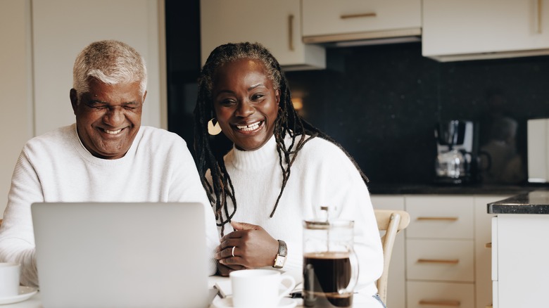 Couple researches on laptop