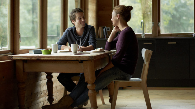 Couple converses over breakfast