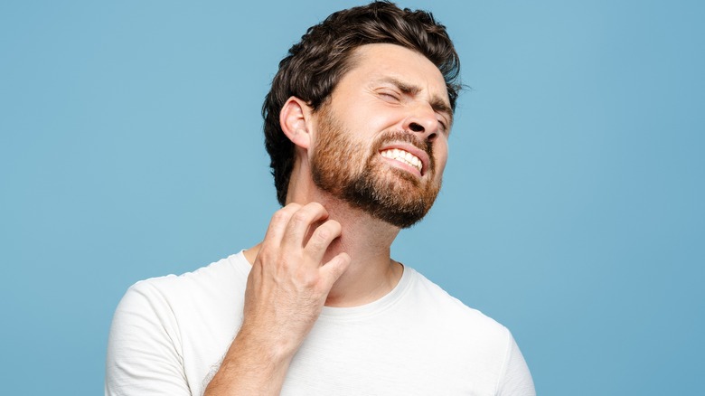 Man scratching his beard