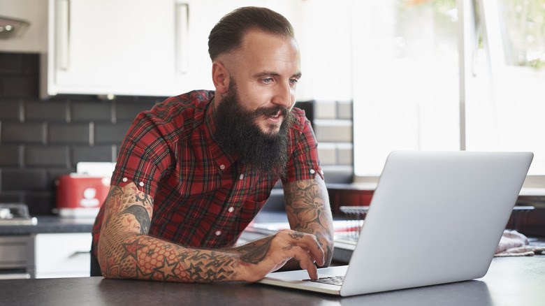 Bearded man using laptop