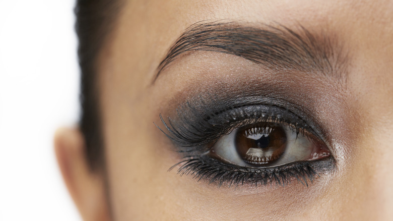 Close up of a woman with a smokey eye and mascara