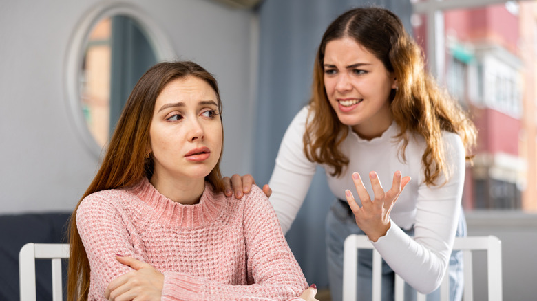 Woman nagging another woman at the table