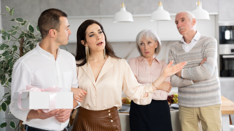 Woman talking in a kitchen with family