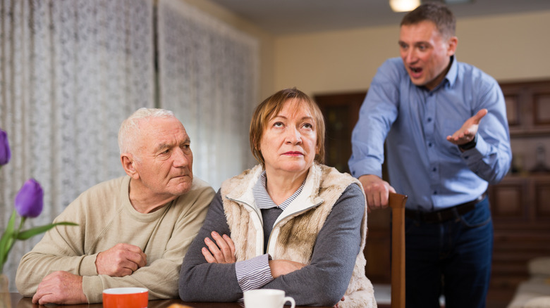 Woman rolling her eyes at a man arguing