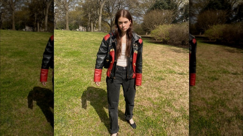 woman wearing baggy pants and red/black jacket