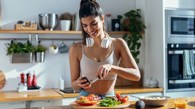 Smiling woman preparing healthy meal