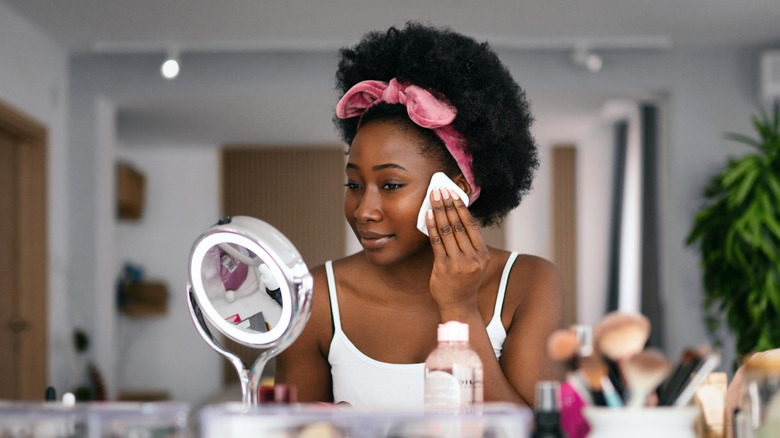 woman taking off makeup