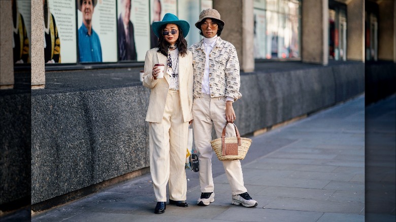 Couple with raffia Loewe tote bag.