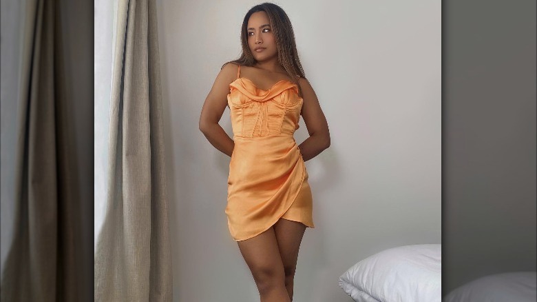 Girl in orange corset style dress.