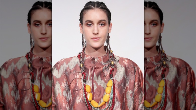 model wearing large beaded necklace