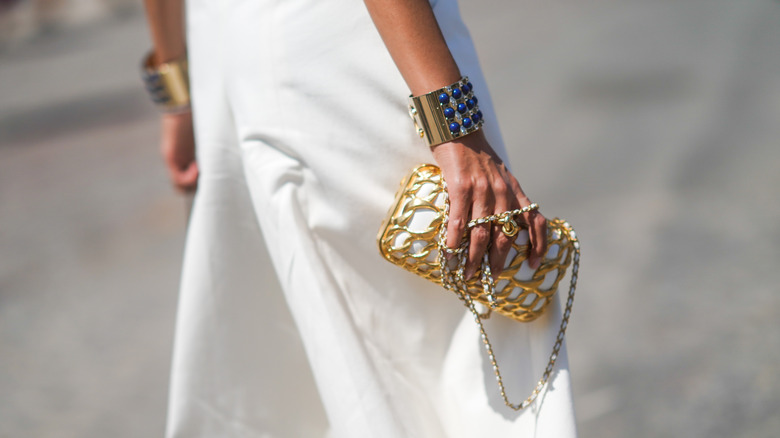 Woman wearing gold cuff bracelet