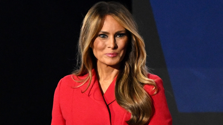 Melania Trump wearing a red jacket