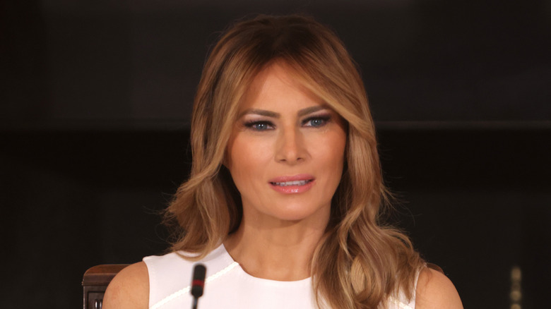 Melania Trump wearing a white dress