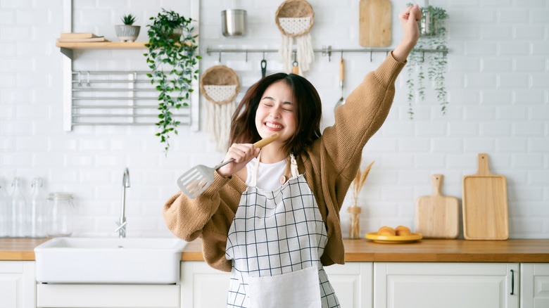 Woman dances in kitchen