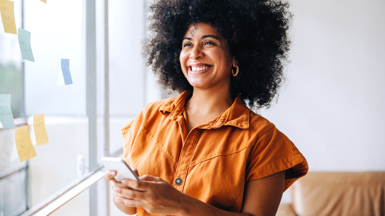 Confident woman smiles in office