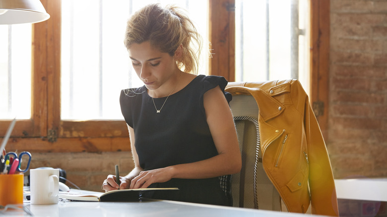 Woman writes in journal 