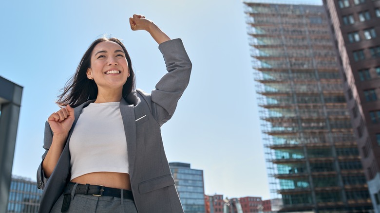 Woman raises fist on city street