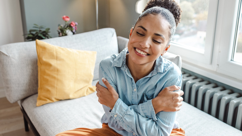 Woman hugs herself