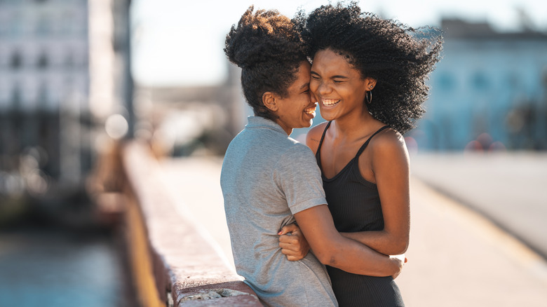 Two people happily embracing outside