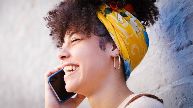 Smiling woman talking on phone