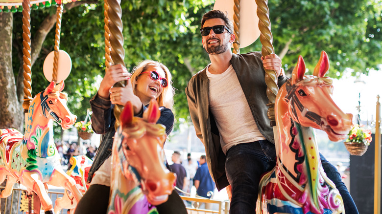 Smiling couple on merry-go-round