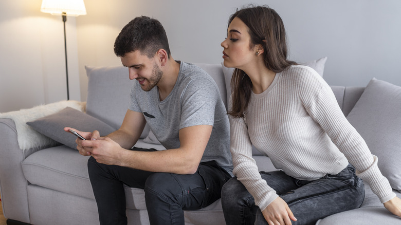 woman looking at man's phone