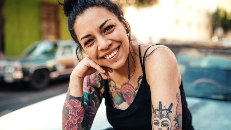 Smiling woman with arm tattoos