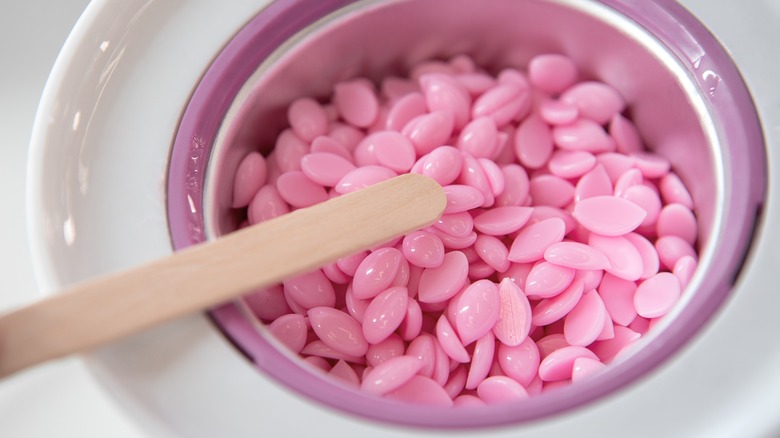 Pink wax pellets in wax heater