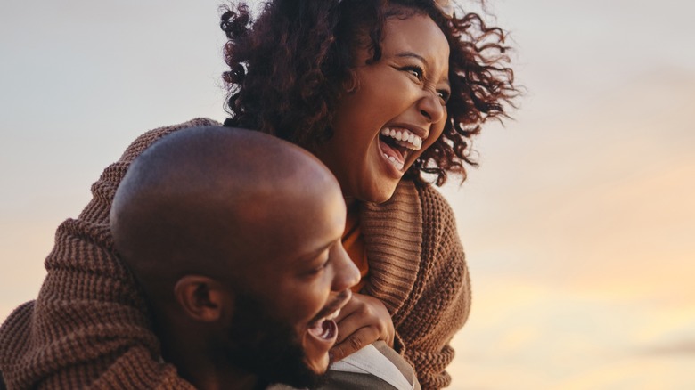 Couple laughing in sunset