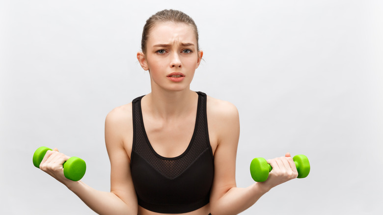 Woman upset lifting weights