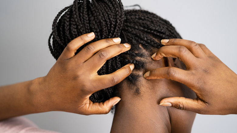 Woman scratching itchy scalp