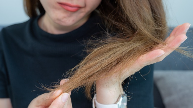 Woman frowning at dull hair