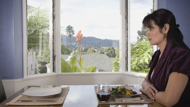 Woman sitting at table alone