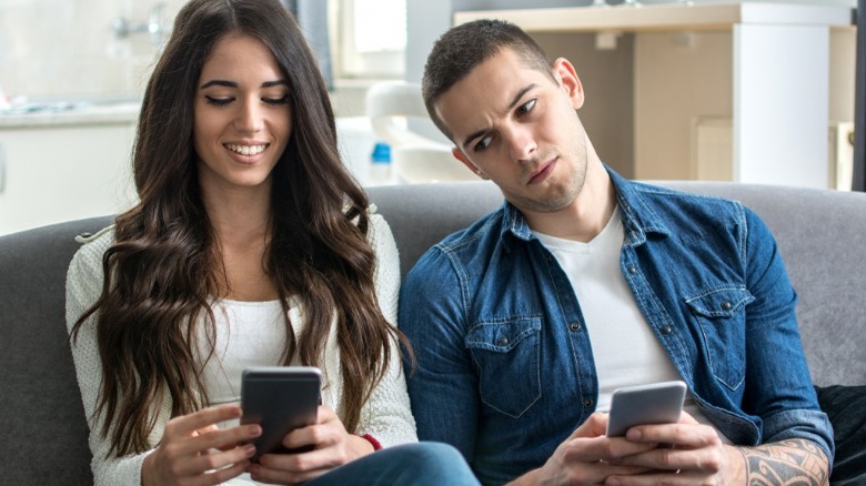 Man looking at woman's phone