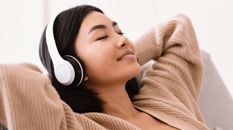 Asian woman relaxing with headphones