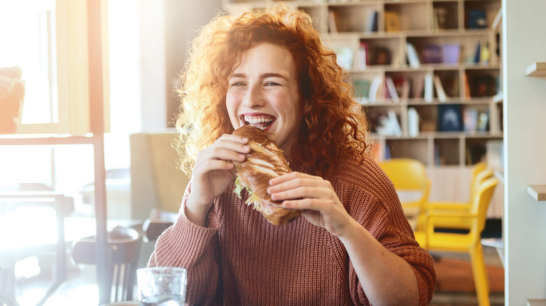 woman eating sandwich