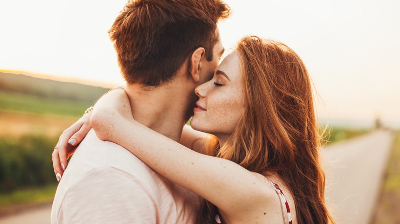 Couple hugs outdoors