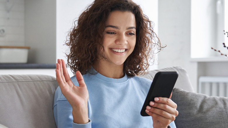 Woman calling a friend, smiling