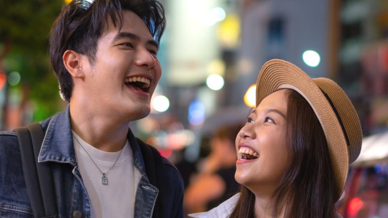 Couple laughing on busy street