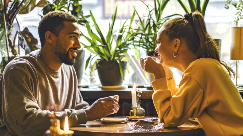 Smiling couple leaning toward each other